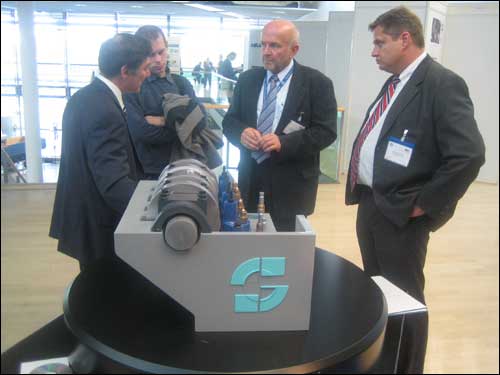 PHOTO CAPTION: Stephen Scuderi and Lutz Deyerling explain the valve train model on display at FISITA 08 in Munich.